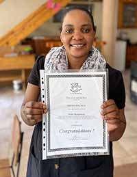 Betty with her Home Management Course certificate